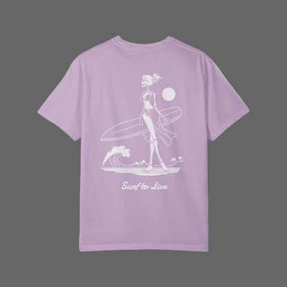 Lavender t-shirt with a graphic of a woman holding a surfboard and text 'Surf to Live' on a white background