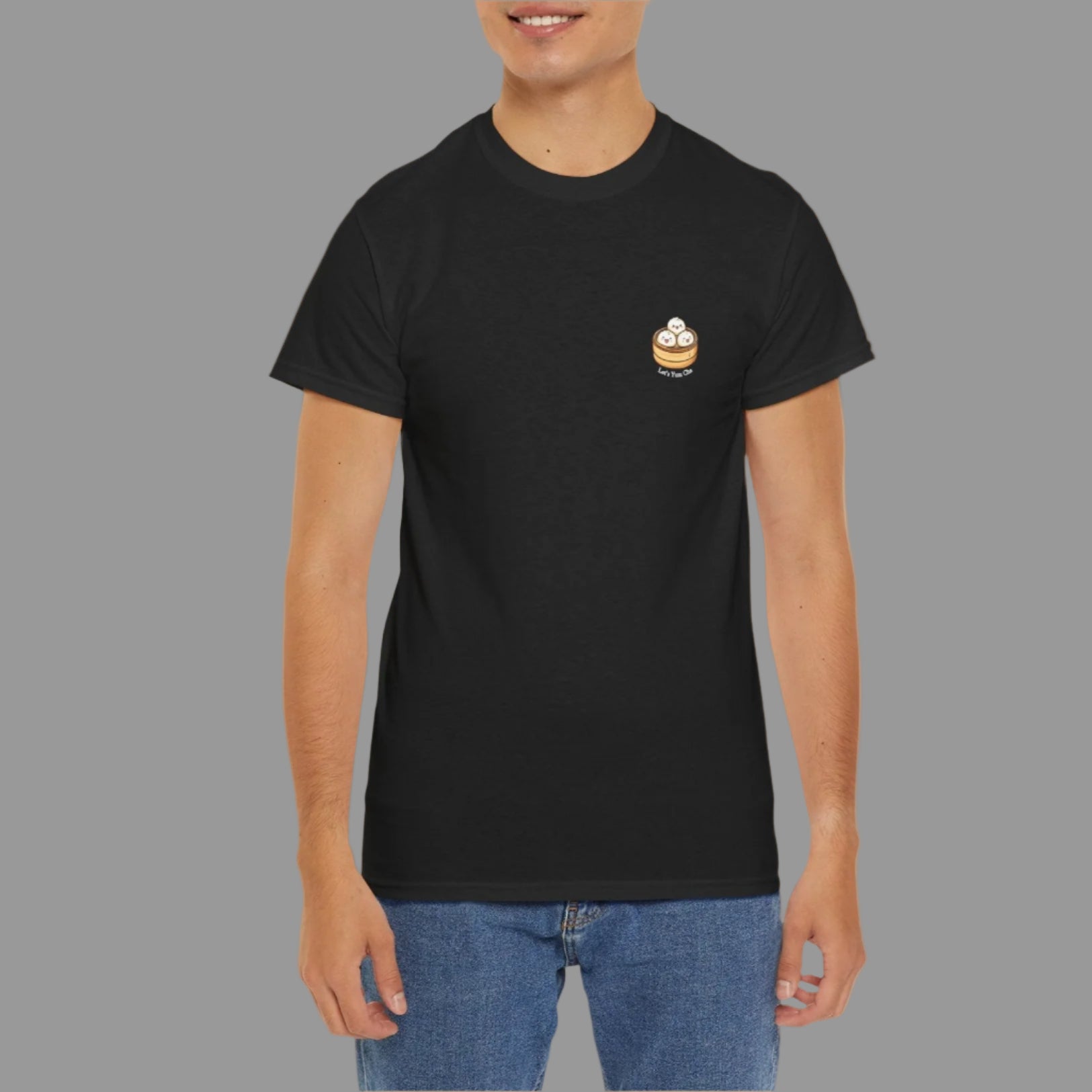 Person wearing a black t-shirt with a small logo on a white background