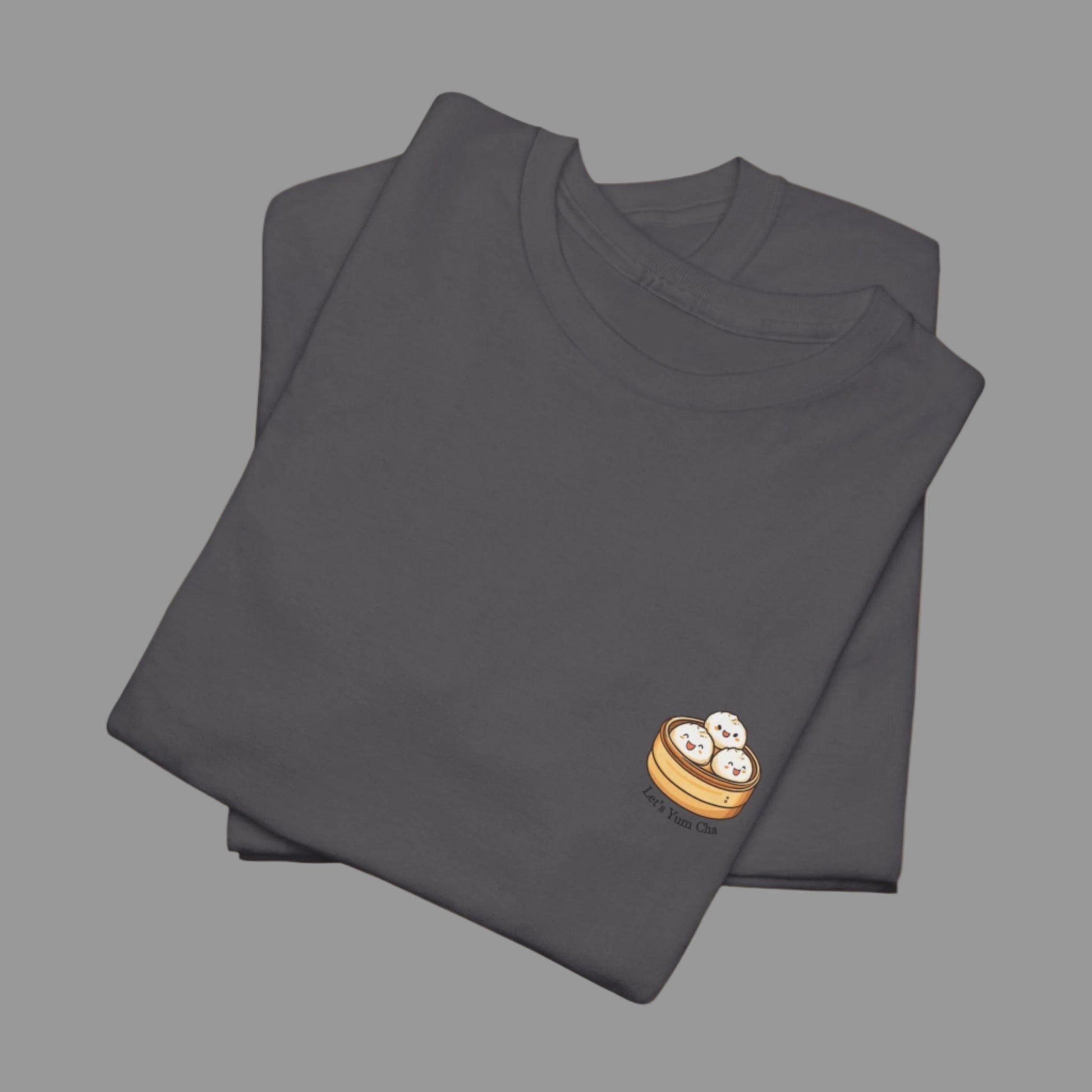 Folded dark gray t-shirt with a small logo on a white background