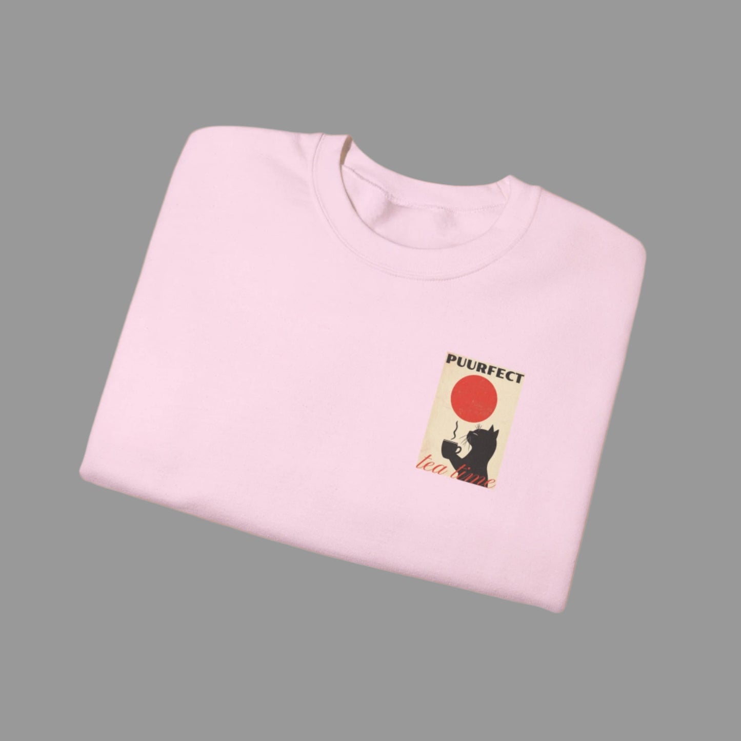 Folded pink sweatshirt with a graphic design on a white background