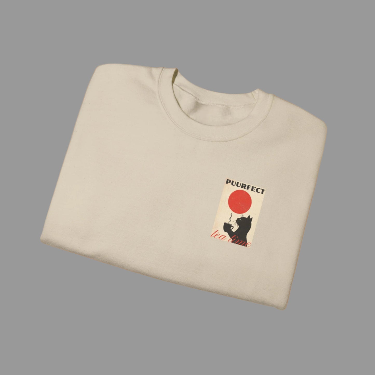 Folded beige sweatshirt with a graphic design on a white background