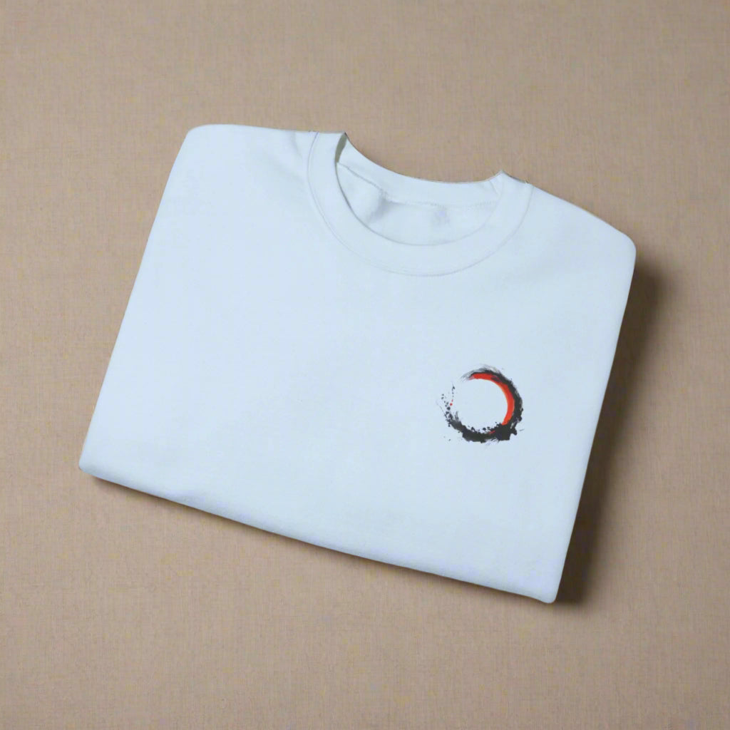 Folded light blue t-shirt with a small design on a white background