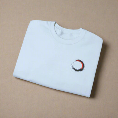 Folded light blue t-shirt with a small design on a white background