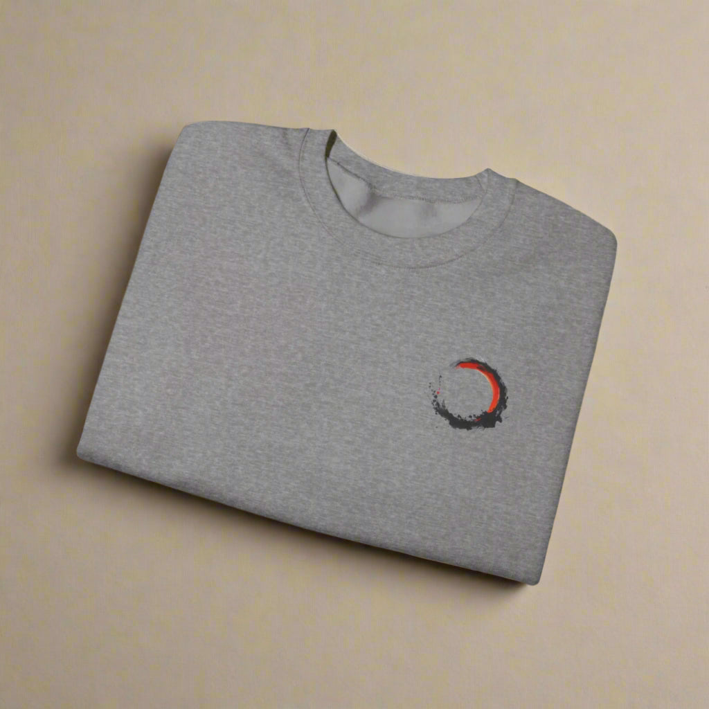 Folded gray t-shirt with a small logo on a white background