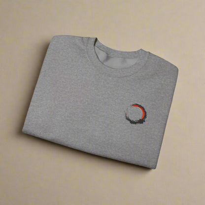 Folded gray t-shirt with a small logo on a white background