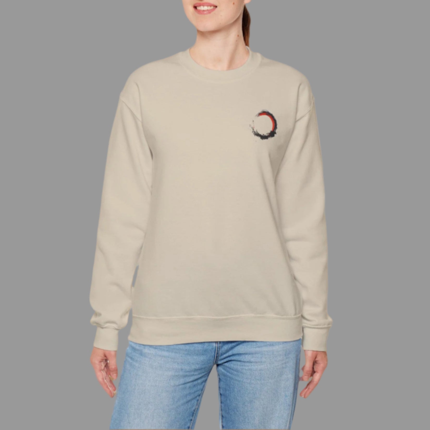 Woman wearing a beige sweatshirt with a small design on a white background