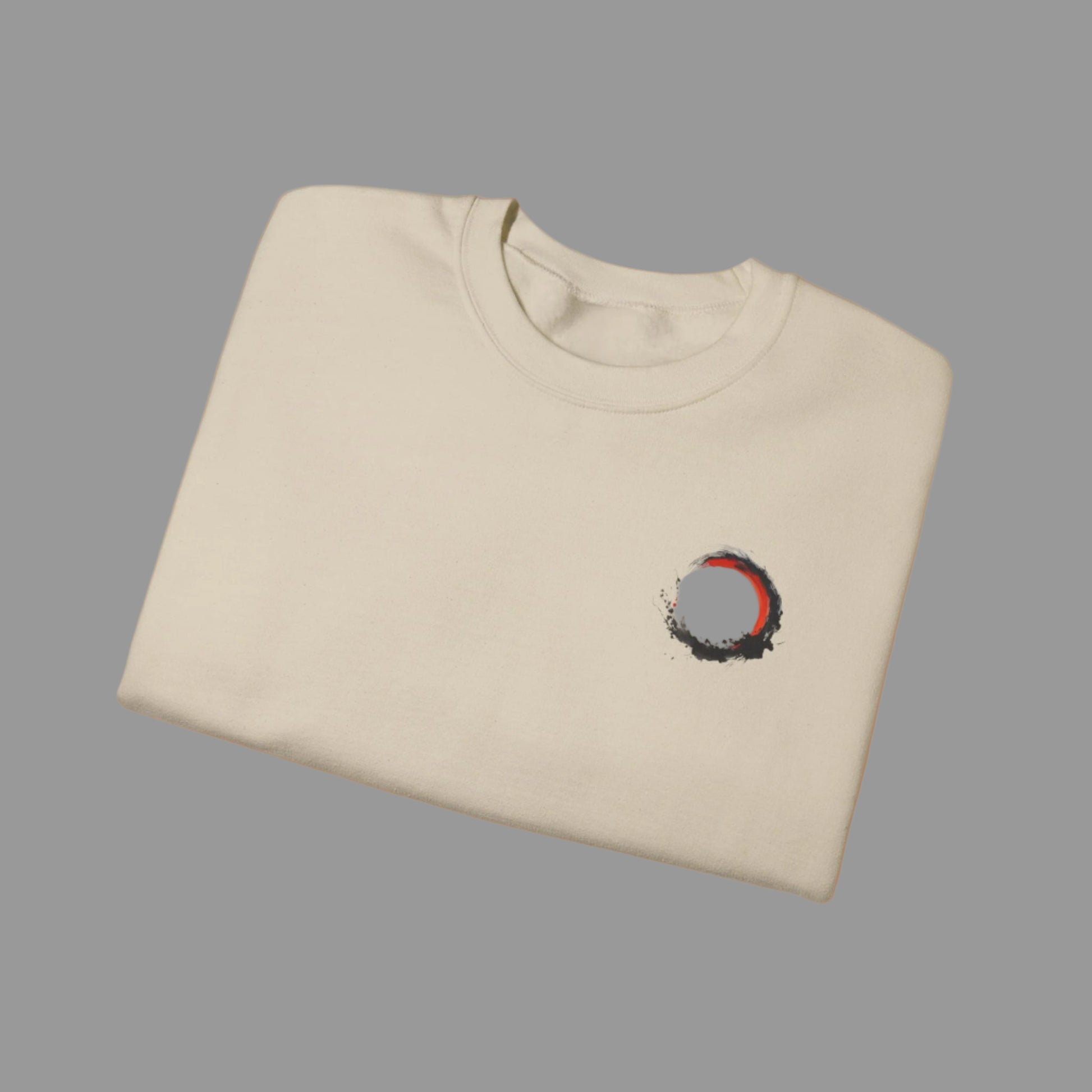 Folded beige t-shirt with a small design on the chest against a white background