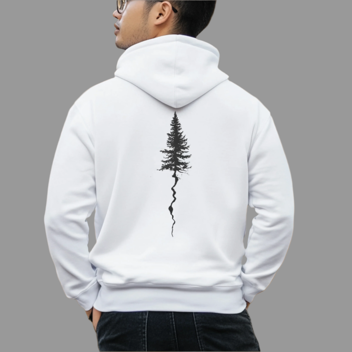 A person wearing a white hoodie with a black tree graphic on the front.