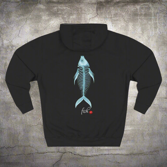 A person wearing a black fleece hoodie with a fish bone design on the back, standing against an orange background.