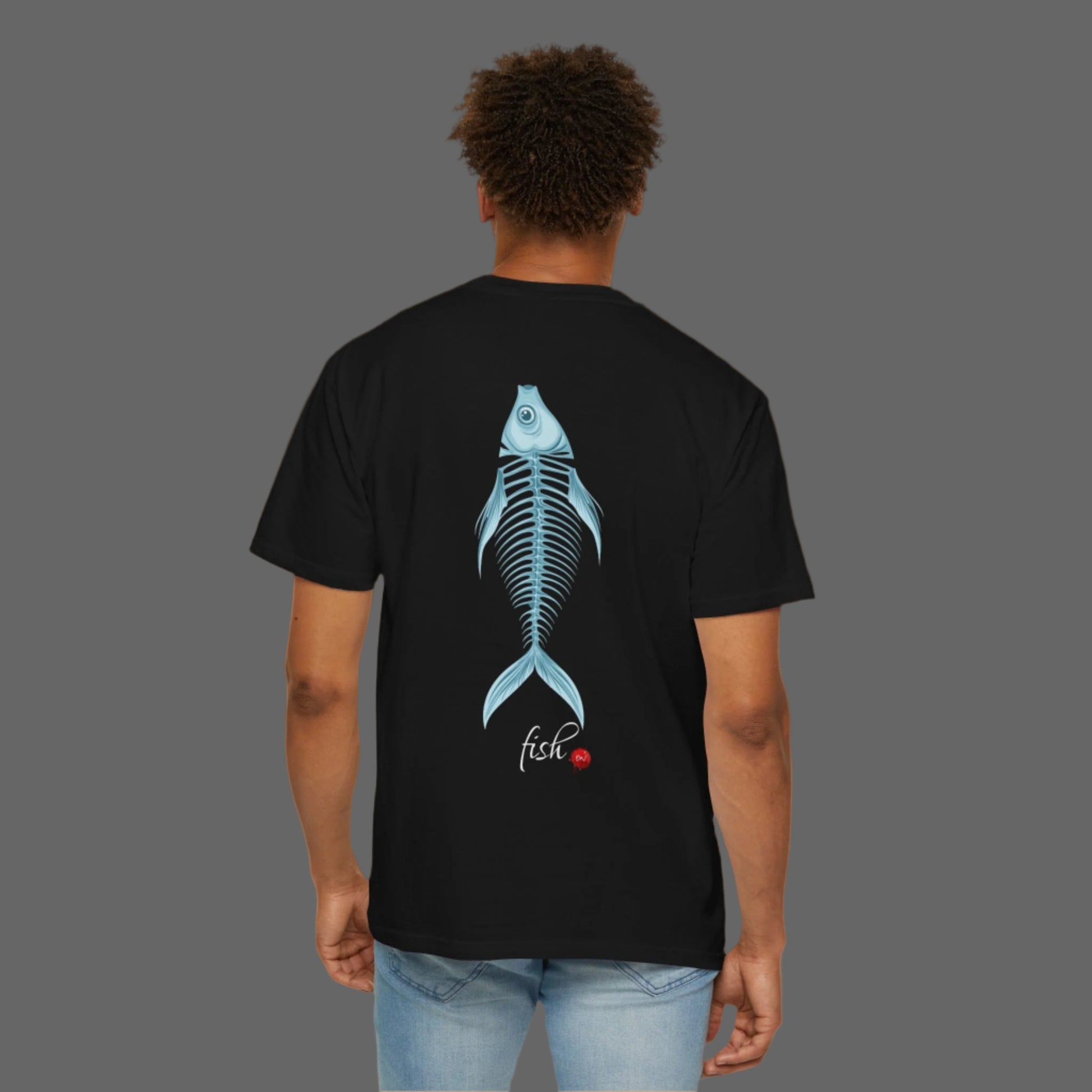Person wearing a black t-shirt with a blue fish skeleton design on the back, standing against a white background.