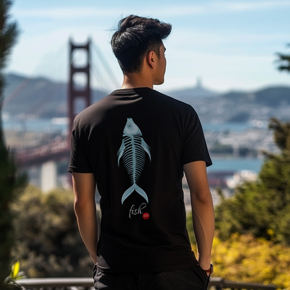 Person wearing a black t-shirt with a fish design, standing in front of the Golden Gate Bridge.