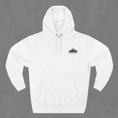 A person wearing a white fleece hoodie with a hood, featuring a small embroidery design on the chest.